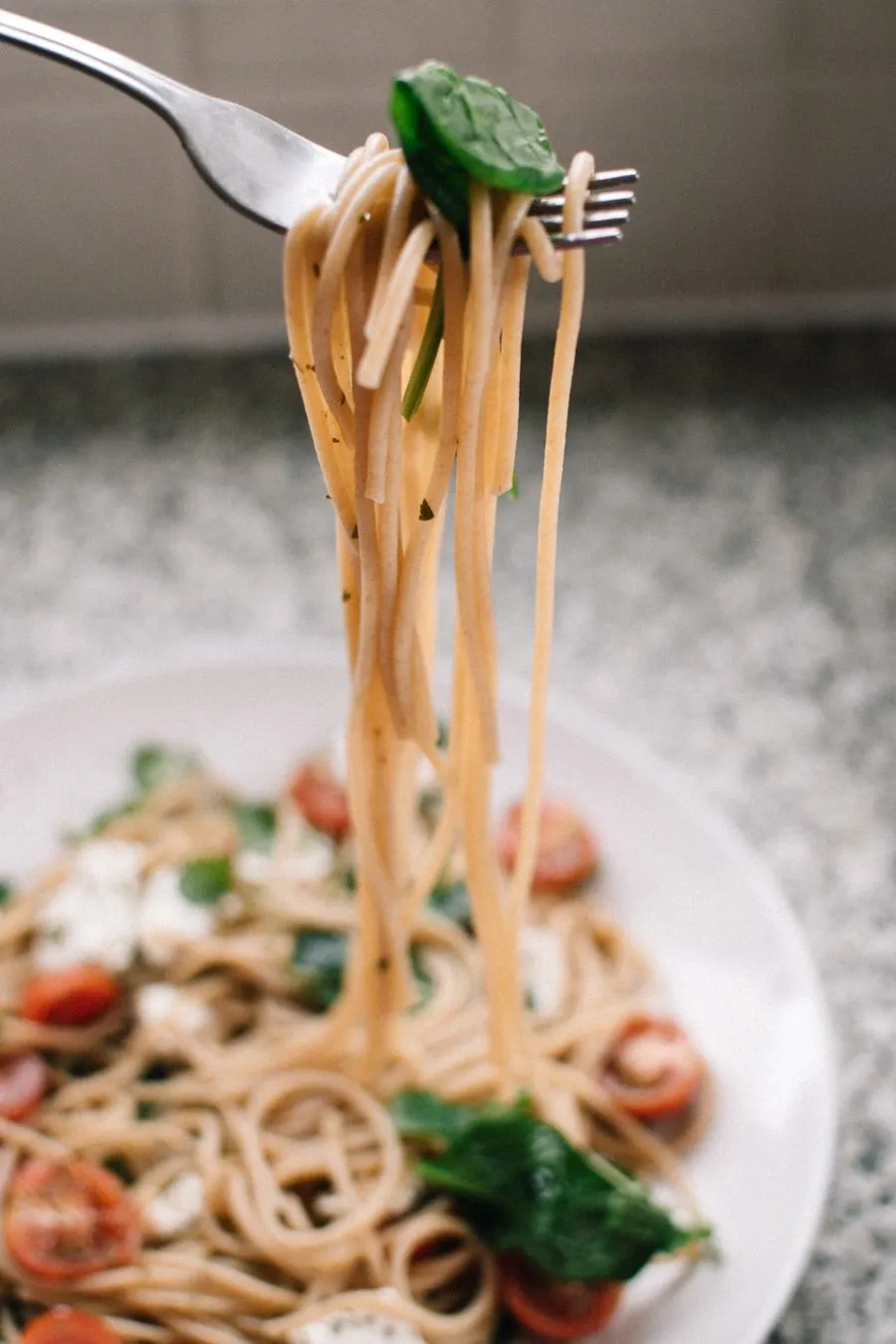 A bowl of pasta on a kitchen table